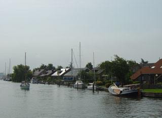The Zijlroede channel into Lemmer is lined with riverside houses and bungalow parks